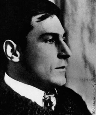 A historical black-and-white photograph of the painter Franz Marc in profile, wearing a shirt collar and a patterned tie.