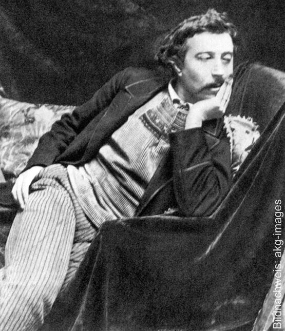 Historisk sort-hvid-fotografi af den franske kunstner og maler Paul Gauguin, der ligger eftertænksomt på en sofa med hovedet støttet på hånden.
